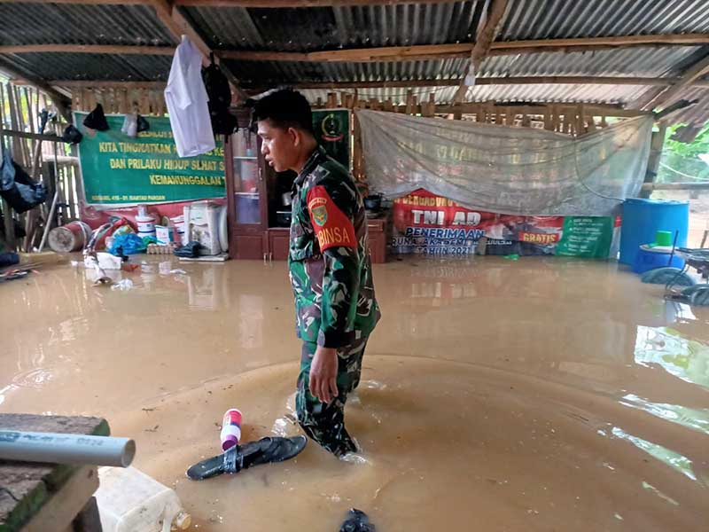 Danramil 01/Rantau Pandan Kodim 0416/Bute Kapten Inf Syaiful Anwar Bantu Angkat Barang Warga Kebanjiran ketempat yang Lebih Aman. FOTO : Dhea/Lt  