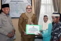 Momen Bupati Tanjab Timur, Hj. Dillah Hikmah Sari, S.T., secara simbolis menyerahkan bantuan produktif dan konsumtif dari Baznas Tanjab Timur kepada warga penerima manfaat (mustahik) bertempat di Kantor Camat Rantau Rasau. (FOTO : Dok. Diskominfo TJT)