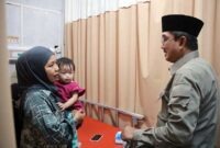 Bupati Tanjung Jabung Barat, Anwar Sadat, berbincang dengan seorang ibu yang mendampingi anaknya saat menjalani perawatan di RSUD KH. Daud Arif, Kuala Tungkal, Jumat (16/10/2026), dalam kunjungan kepada pasien gangguan pernapasan di tengah kabut asap.

(FOTO: Dok. Prokopim)