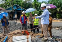 TINJAU PROYEK: Bupati Tanjung Jabung Barat, Drs. H. Anwar Sadat, M.Ag., memberikan instruksi saat meninjau pengerjaan box culvert di Jalan Nasional Lintas Timur, Desa Tanjung Bojo, Selasa (12/5). Proyek ini ditargetkan menjadi solusi permanen untuk mengatasi masalah banjir yang kerap menggenangi wilayah tersebut saat curah hujan tinggi. (FOTO : Dok. Prokopim)