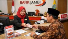 SENYUM YANG TERENGGUT: Pemandangan transaksi di teller Bank Jambi yang kini menjadi satu-satunya tumpuan nasabah. Di era serba digital, lumpuhnya sistem memaksa ribuan nasabah kembali ke cara-cara konvensional—antre berjam-jam demi menarik uang sendiri. Sebuah ironi besar bagi institusi yang sempat memimpikan modernitas, namun kini justru terlempar kembali ke masa lalu akibat bobolnya sistem senilai Rp143 miliar. (FOTO : Dok. Istimewa/LT)