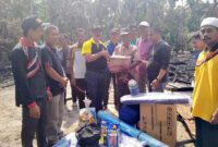 FOTO : Kepala Dinas Sosial Drs. Sarifudin, MM Menyerahkan Bantuan Kepada Korban Musibah Kebakaran di RT 03 Desa Sungai Landak, Kecamatan Senyerang, Jumat (13/03/20).