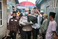 FOTO : Kapolres Tanjab Barat AKBP Guntur Saputro, SIK, MH mengendong Jenazah Febri Riyanty Menuju TPU jalan Balai Marga, Kelurahan Tungkal III, Minggu (07/06/20)