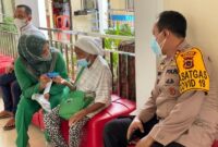 Kapolres Tanjab Barat AKBP Guntur Saputro, SIK, MH dampingi Nenek Minah divaksin, Rabu (21/07/21).