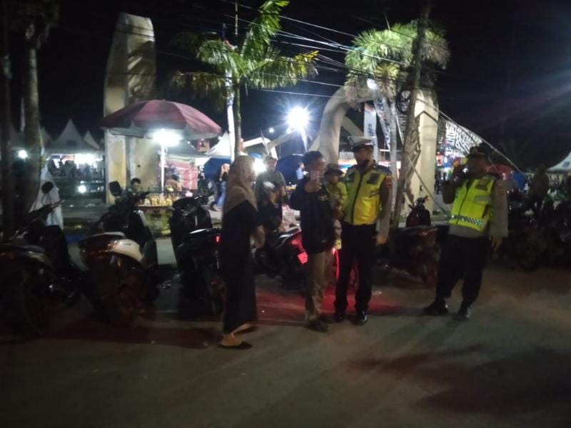 Warga (Pengunjung) IPP-TJB Expo foto bersama petugas Kepolisian Polres Tanjab Barat di Alun - Alun Kota Kuala Tungkal, Sabtu (31/12/22) Malam. FOTO : Bas/LT