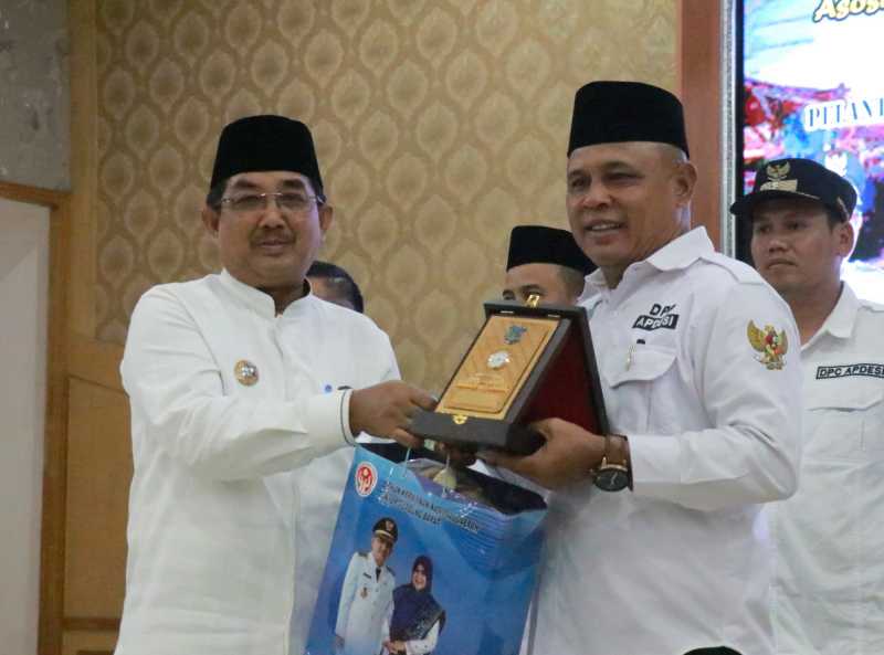 Bupati Tanjung Jabung Barat H Anwar Sadat menyerahkan Cinderamata kepada Ketua DPD Apdesi Jambi Samsul Fuad. FOTO : Istimewa