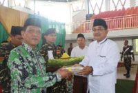 Bupati Drs H Anwar Sadat, M. Ag menerima potongan tumpeng saat peringatan Harlah dan Mulimat NU (Prokopim)