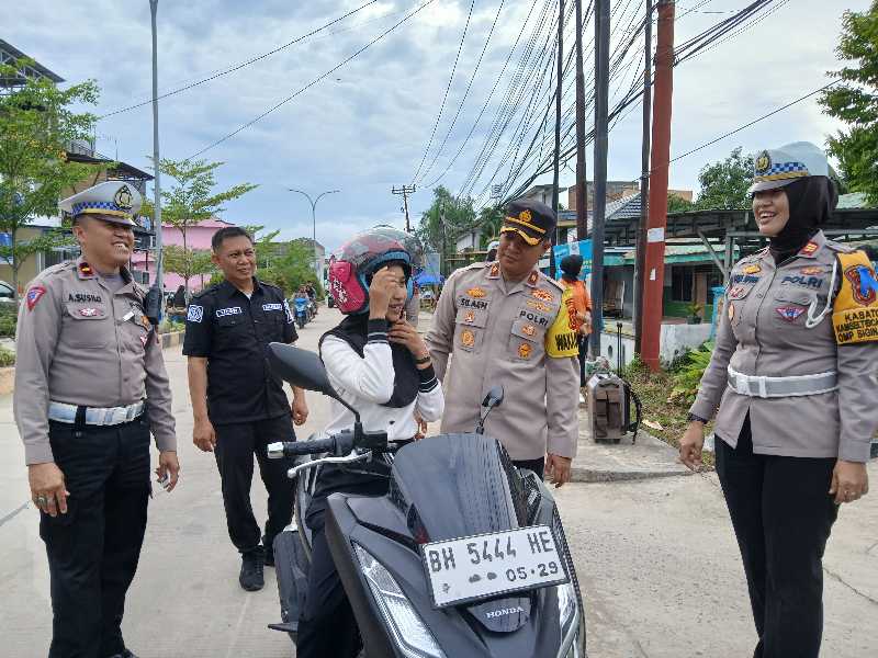 Wakapolres Tanjab Barat Kompol Johan Christy Silaen, Kasatlantas AKP Rita Purnama Sari, KBO Satlantas, Kasi Humas saat berikan Helm ke pengendara (Dok LT)