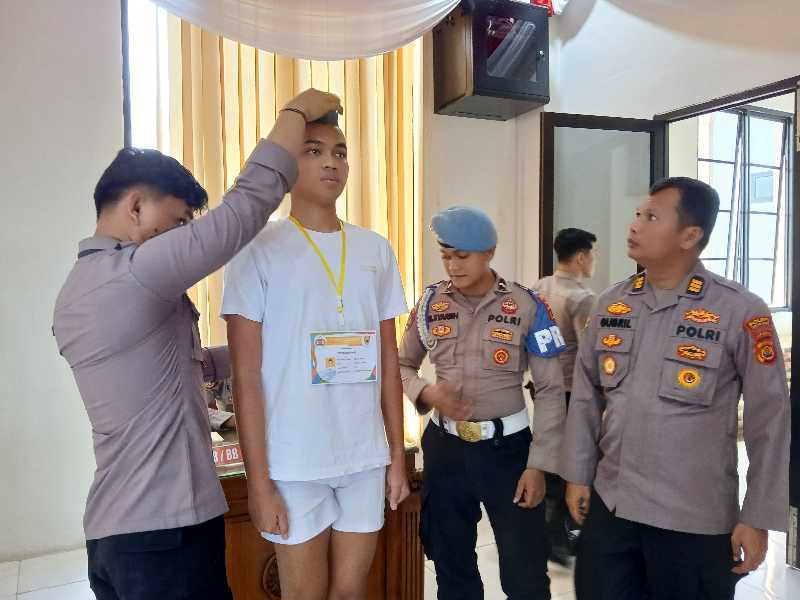 Ketua Pelaksana Giat Rikmin Awal Pabanrim Polres Tanjab Barat AKP Gubril dan Anggota Saat Mengukut Tinggi dan Berat Badan Peserta (Ist)