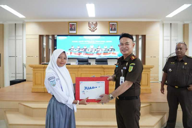 Kajari Tanjab Barat Anton Rahmanto Menyerahkan Hadiah Kepada Juara Lomba Video Kreatif Harkodia 2025 (hms)