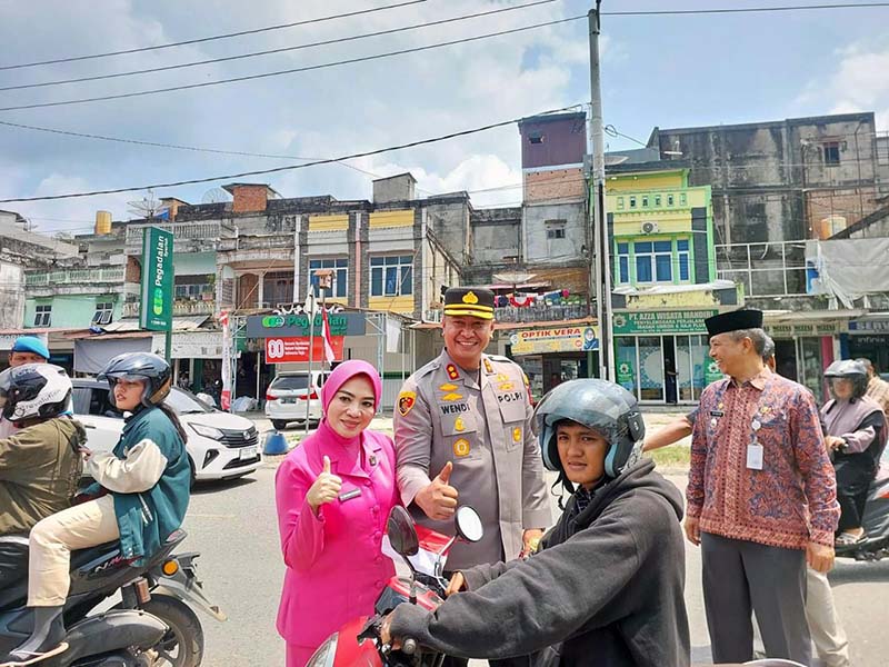 Kapolres Sarolangun AKBP Wendi Oktariansyah, S.I.K., M.H didampingi Ketua Bhayangkari Bagikan Bendera Merah Putih ke Warga Singkut, Kamis (7/8/2025). FOTO : DHEA