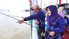 Bupati Tanjab Barat Anwar Sadat didampingi istri, Hj. Fadhilah Sadat, memantau langsung jalannya Lomba Mancing Semarak HUT RI dan HUT Kabupaten Tanjab Barat di area ikonik WFC Kuala Tungkal, Kamis (6/8/2026). (Foto: Istimewa)