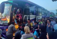 PENGAMANAN MELEKAT: Sejumlah personel Polres Tanjab Barat bersama panitia PPIH Provinsi Jambi bahu-bahu mengawal dan membantu Calon Jemaah Haji (CJH) Kloter 21 Kabupaten Tanjung Jabung Barat saat memasuki bus pariwisata di Alun-alun Kota Kuala Tungkal, Jumat pagi (15/5/2026). Sinergi ketat di lapangan memastikan proses keberangkatan 275 jemaah gelombang pertama berjalan aman, tertib, dan kondusif. (FOTO : Dok. Humas Polres TJB)