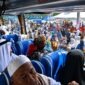  Dari balik jendela bus, jemaah haji Kloter 24 melambaikan tangan ke arah ratusan keluarga dan warga yang telah memadati Alun-alun Kota Kuala Tungkal, Senin (29/06). (FOTO : Dok. Prokopim)