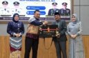 Bupati Tanjab Barat H. Anwar Sadat menyerahkan plakat penghargaan dan cindera mata kepada AKBP Maulia Kuswicaksono sebagai bentuk apresiasi atas dedikasinya selama menjabat sebagai Kapolres Tanjung Jabung Barat, Jumat (11/09/2026). (FOTO : Dok. PROKOPIM)