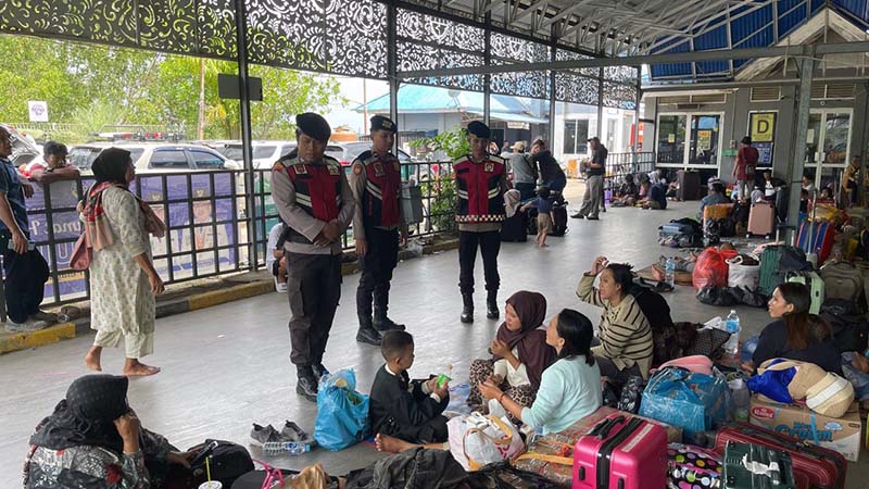 Personel Sat Samapta Polres Tanjab Barat saat berinteraksi dan memberikan imbauan keamanan kepada para penumpang di Pelabuhan Roro Kuala Tungkal, Sabtu (25/04/2026). Kegiatan ini bertujuan untuk memastikan keamanan barang bawaan dan kenyamanan masyarakat selama libur akhir pekan. (FOTO : Humas Res Tanjab Barat)